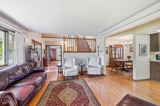 From the living room towards the front entry, the office, and the staircase to the second floor.