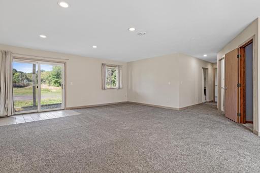 Walk out and great area that leads to a hallway, bathroom, utility room and 2 bedrooms!