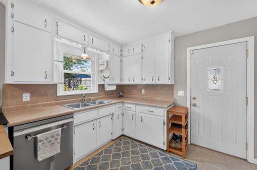 This Kitchen is just darling and filled with plenty of storage and work space. Easy access to the backyard too!