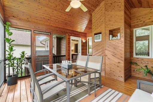 The inviting screen porch blends the comfort of indoor living with the beauty of the great outdoors.