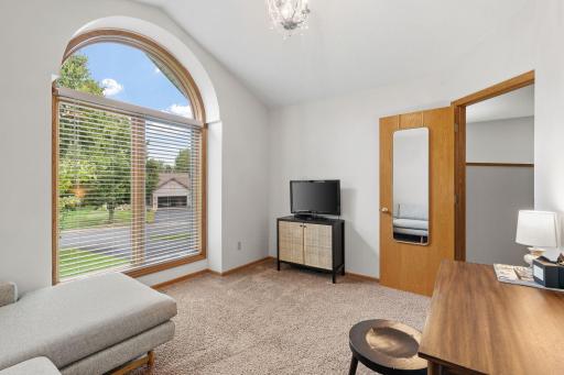 This main floor bedroom or office, with the floor to ceiling window and vaulted ceilings is a room that will be sure to provide relaxation.
