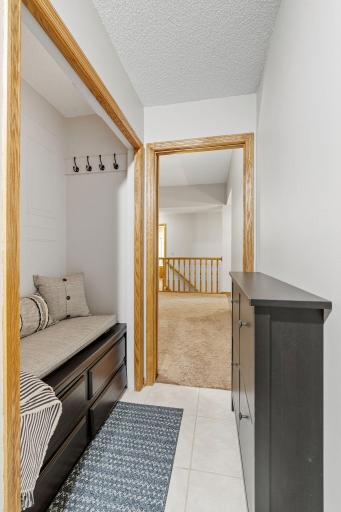 Combined with the laundry room is a mudroom off garage with a built in bench and hooks.