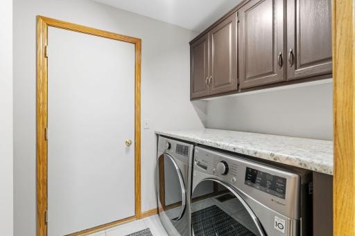 Main floor laundry is tucked away between a pocket door and a sliding barn door right off the kitchen.