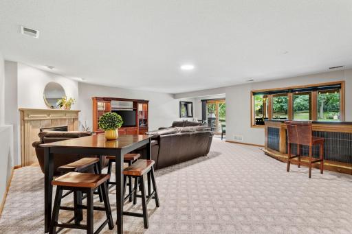 Large family room with bar area, second fireplace and a walkout to the patio