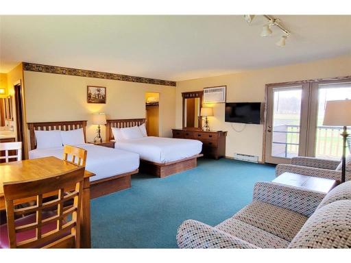 Upper level bedroom. Two queen beds and a sleeper sofa. Tons of space. Deck overlooking Alec's 9 golf course.