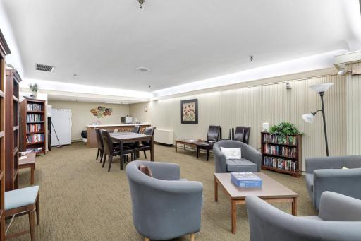 Spacious resident community room offering comfortable seating, dining and gathering areas, books and games, plus a kitchenetteâideal for relaxing or socializing with neighbors.