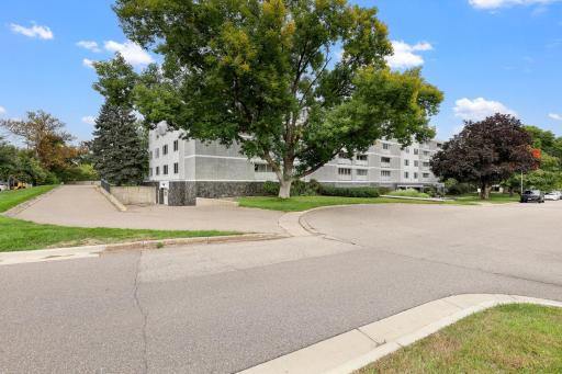 Well-kept building set on a quiet, tree-lined corner with manicured lawns and underground garage access.