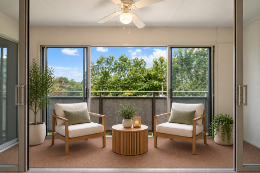 Virtually staged enclosed balcony featuring expansive windows, natural light, and a flexible layout ideal for relaxing and enjoying the surrounding views.