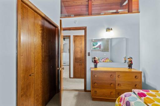Warm wood trim and ample closet space continue the home’s distinctive character into the bedrooms