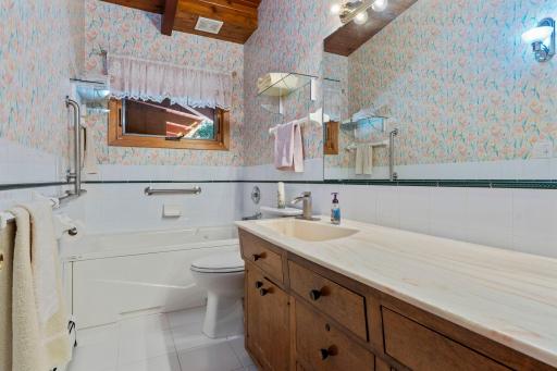 Main floor full bath offers a spacious vanity with plenty of counter space and storage