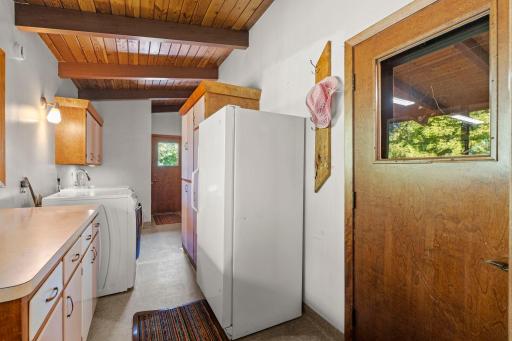 A convenient laundry area offers additional storage and workspace just off the kitchen