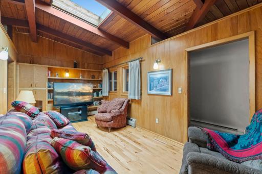 Built-in shelving provides extra storage and display space, while a skylight brings in natural light