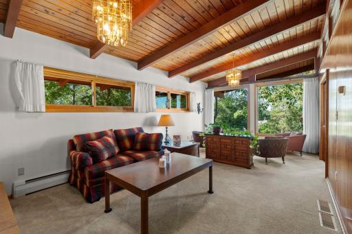The spacious family room makes an immediate impression with its beautiful wood-plank ceiling and exposed beams