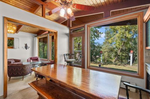 Gather around the large dining table with beautiful backyard views framed by oversized windows