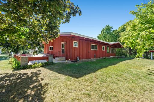 The backyard continues the home’s private feel with plenty of open lawn and mature trees surrounding the property