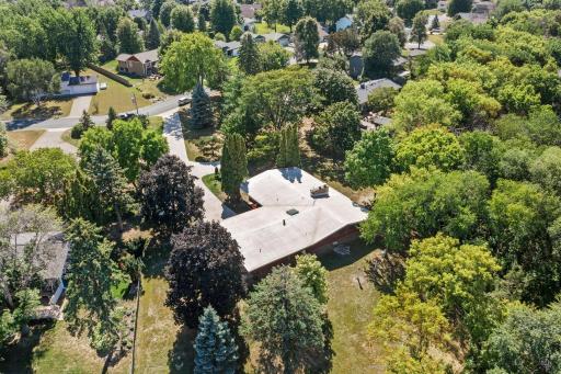 An aerial perspective showcases the home’s private setting and generous separation from neighboring properties