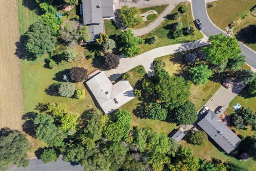 A bird’s-eye view showcases the home’s sprawling 1.2-acre setting and the beautiful mature trees surrounding the property