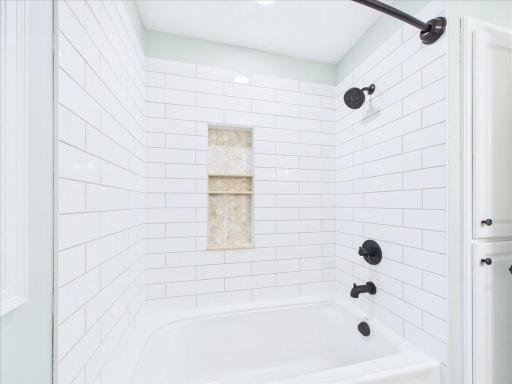 2nd bath has lovely tile surround