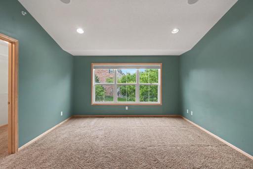 Primary bedroom with large window giving the room an abundance of natural light