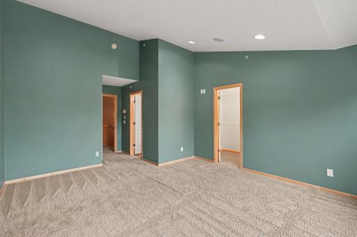 Primary bedroom boast vaulted ceilings and built in speakers