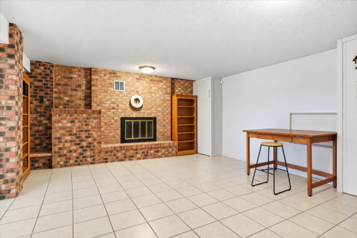 The homeâs fourth wood-burning fireplace creates a cozy focal point in the basement recreation room!