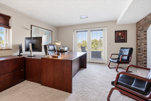 Work from home in this inviting lower-level office featuring a gorgeous brick fireplace and backyard walkout!