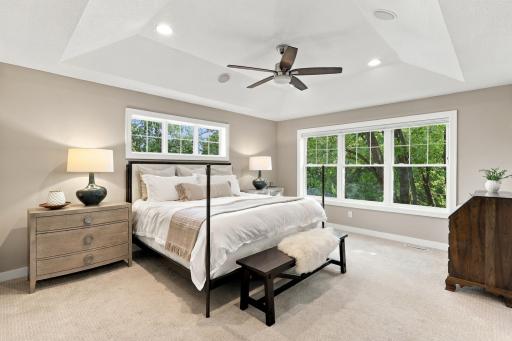 Primary bedroom overlooks backyard