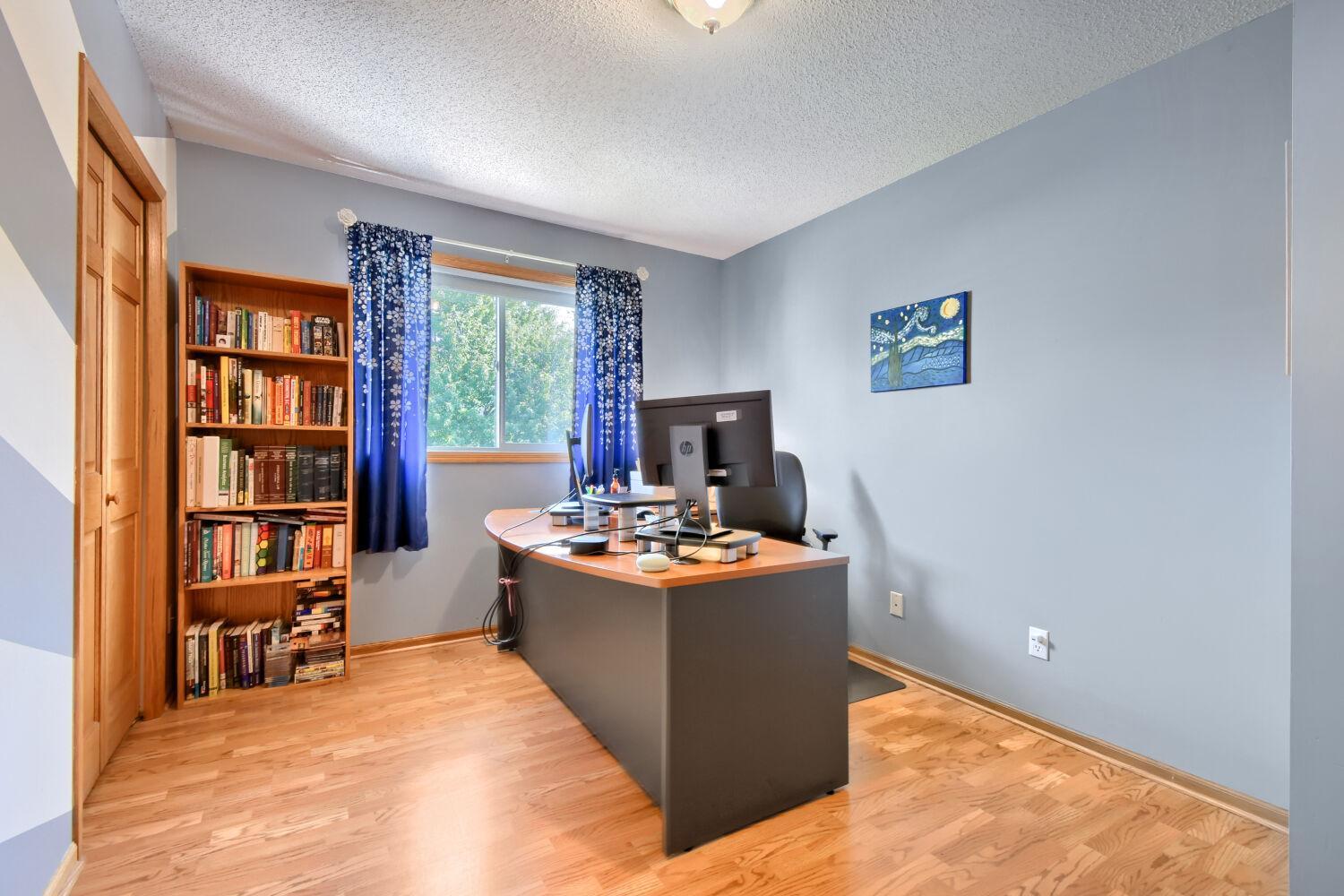 One of 3 upper level bedrooms used as office.