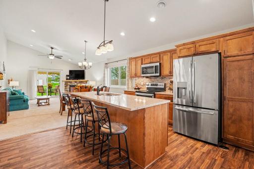 The bright, open kitchen features a large island w/granite countertop, dual sink w/disposal, GE dishwasher & a pull down faucet. There is storage in the island & can seat up to 4 stools. The beautiful cabinetry provides abundant storage.