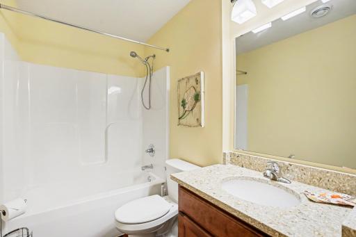 There is a convenient full bathroom in the hallway. It incluides a vanity with storage and a deep linen closet.