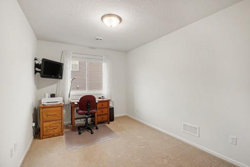 The 2rd back bedroom includes a newer window and a large closet with 3-panel French doors. It's currently being used as an office.