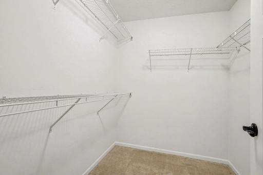 The large walk-in closet includes wire shelves and has ample room for your wardrobe.