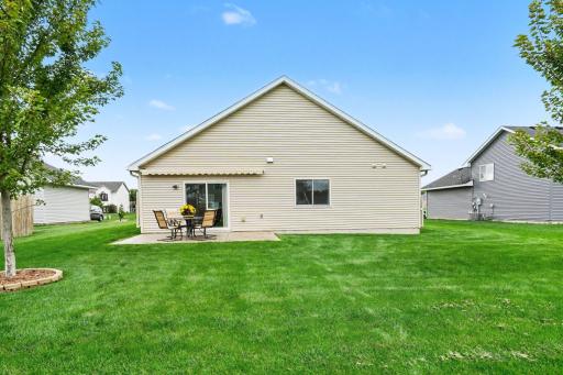 The large, flat backyard includes a Hunter in-ground sprinkler system (2023 & WiFi capable).