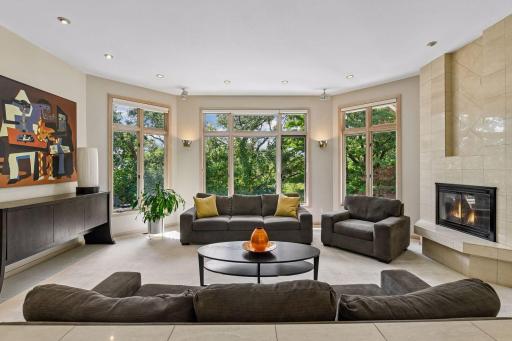 Spacious living area surrounded by wooded views.