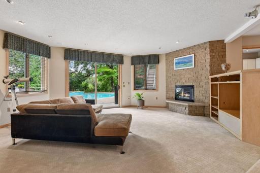 Family room with fireplace and pool access.
