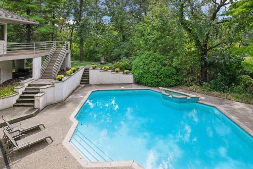 Private in-ground pool surrounded by mature trees.