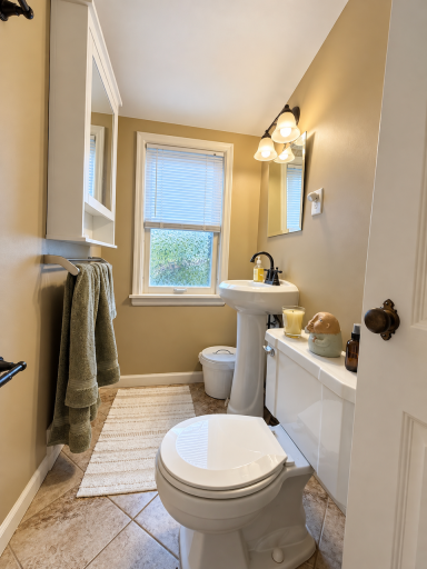Start the day off well with a bathroom just down the hall from the bedrooms. Window light, a pedestal sink and wall shelving make this a convenient stop before heading downstairs for coffee.