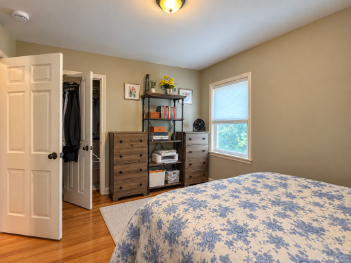 Getting ready is easier when everything has a place. Closet storage and room for dressers keep clothes close at hand, while an insulated window brings in plenty of light into this wood-floored bedroom.