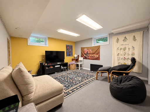 Movie night, game day or a place to catch up with friends. This carpeted lower-level living space has room for a sofa and extra seating, with two high windows bringing in natural light.