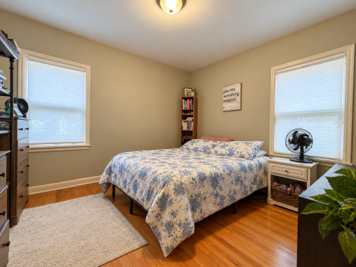 Wake up to light from windows on two walls. Wood floors and space for a bed, bedside table and dressers make it easy to arrange a bedroom around the way you live.
