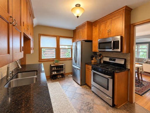 Both kitchens offer fabulous wood cabinetry, stainless steel appliances and a gas range, making everyday cooking inviting. The dining area just through the doorway of 5923 kitchen is seen here.