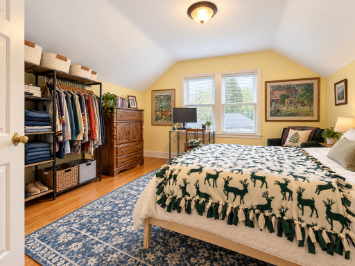 A desk by the windows, a chair for reading and room to stretch out. This upstairs bedroom brings sleep, work and downtime together, with wood floors and paired windows overlooking the trees.