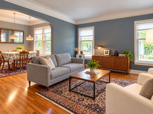 A wide arch in 5923 connects the living and dining rooms while giving each its own space. Wood floors, multiple windows and room for a full dining table make the layout practical for daily living and guests.