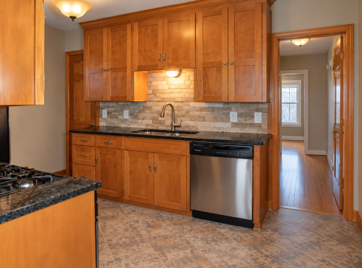 Spread out and enjoy cooking in 5921 kitchen. Generous counters give you room to prep, plate and serve, while wood cabinetry keeps cookware close at hand. A gas range, dishwasher and tile backsplash round out 5921âs kitchen.