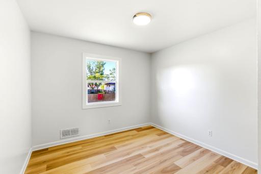Third bedroom upstairs, another bright and inviting bedroom featuring fresh paint, new flooring, an updated window, and a clean, neutral design ready for the new ownerâs personal touch.