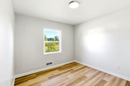 The fifth bedroom offers fresh paint, new flooring, an updated window, and plenty of natural light. This flexible space can also serve as a private home office, guest room, or creative studio.