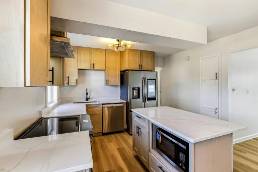 Designed to be the heart of the home, this beautifully renovated kitchen offers abundant cabinetry and storage, generous countertop space, high-end stainless-steel appliances, and a large center island. Super bright, open, and airy layout.