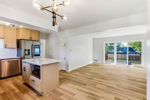 The open-concept floor plan connects the renovated kitchen to a spacious living room, creating a bright and welcoming space for everyday living and entertaining. Sliding glass doors provide abundant natural light and convenient access to the backyard