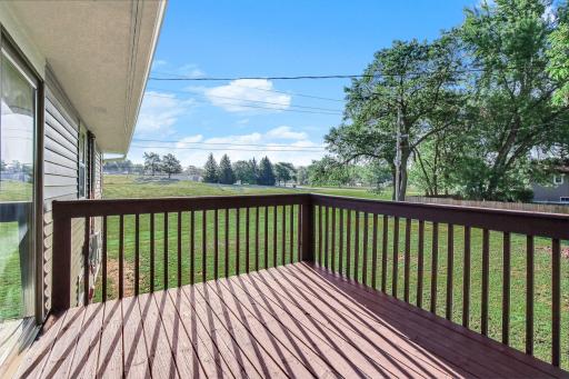 The elevated deck overlooks the spacious backyard, creating the perfect spot to relax while keeping an eye on outdoor activities.