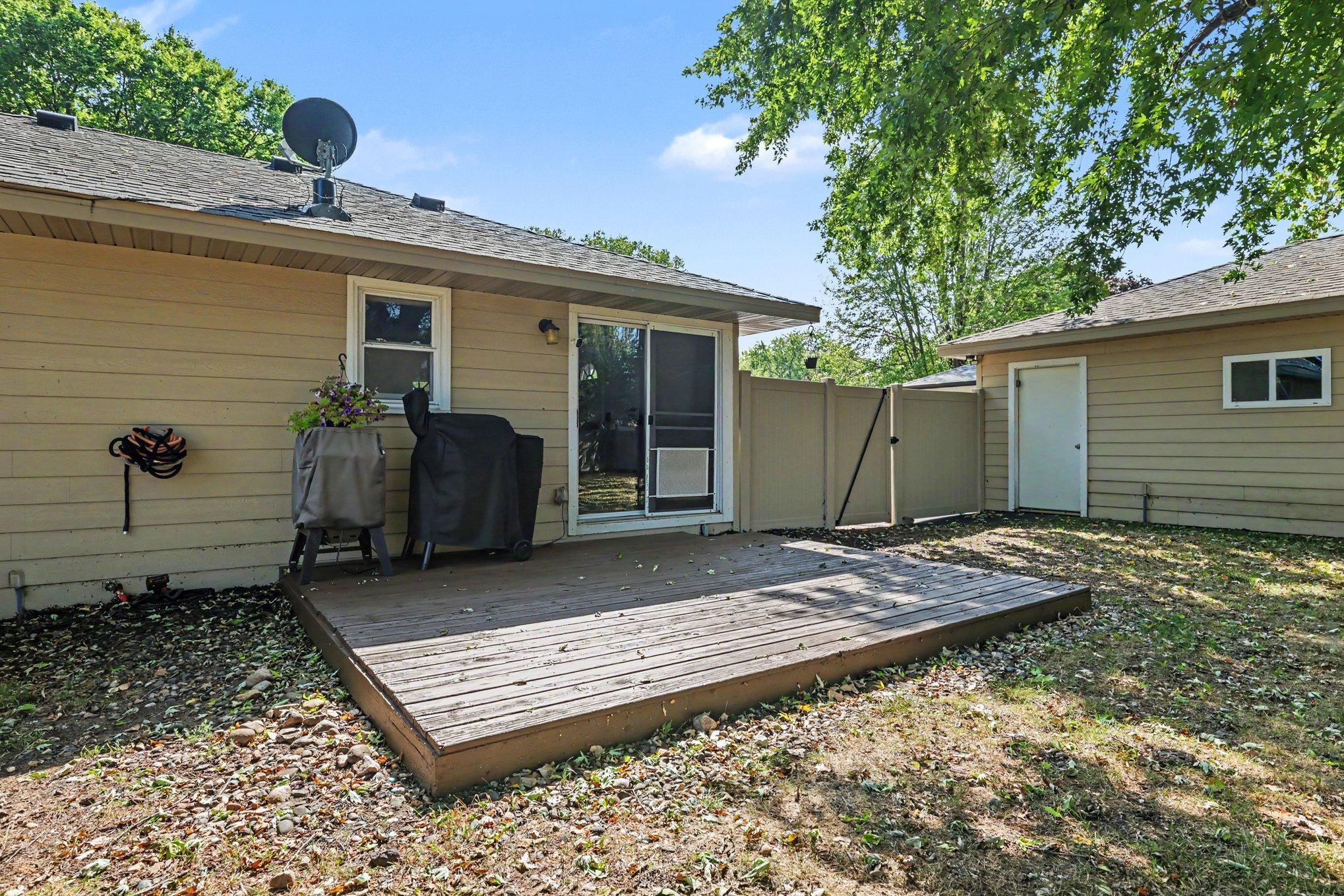 The resealed backyard deck (14'2" x 12'5") is ideal for relaxing or grilling, conveniently situated just outside the informal dining area and kitchen.